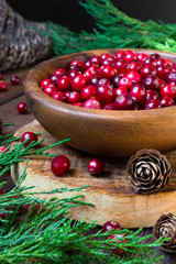 Berries cranberries, drink, jam spruce branches, cones on a dark background with a copy of the space