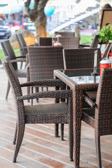 Empty cafe with rattan armchairs