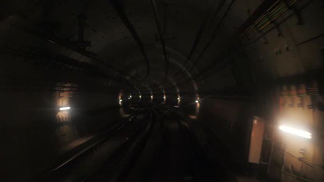 View of a subway tunnel as seen from the front of a moving train. Fast underground train riding in a tunnel of the modern city. long footage of an underground train in Barcelona following its route