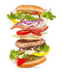 creativ explosion ingredients of a cheesburger hamburger falling down flying concept isolated / fliegende Zutaten fast food konzept
