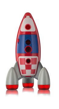 Red blue and white toy plastic childs rocket with reflection isolated on white