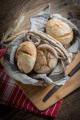Roll breads in basket on table.