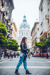 Obraz premium young pretty woman walk old european street with map