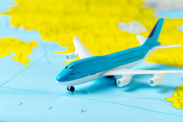 miniature of a passenger aircraft flying on a map