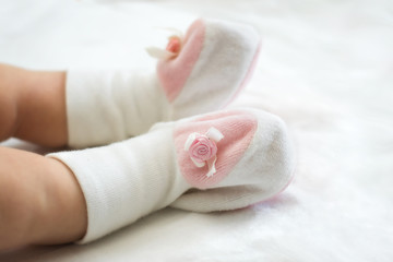 Legs of an infant in a booties