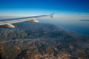 Fototapeta premium Amazing view from the plane window at the sky,the aegean sea and the island of Lesvos.