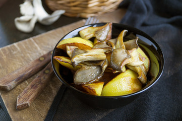 Homemade rustic food: potatoes with mushrooms closeup. vertical top view