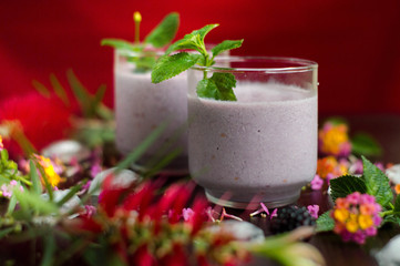 Delicious blackberry milkshake served ready to take.  In the table