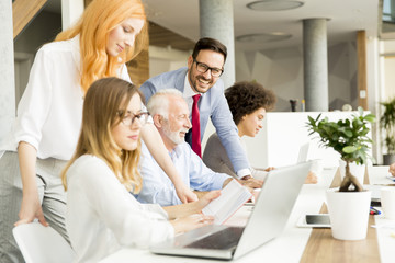 Joyful multiracial business team at work in modern office