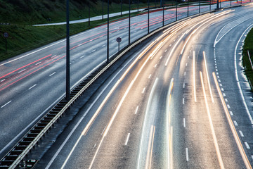 Close-up on Car light streaks on a corner turn of a Motorway