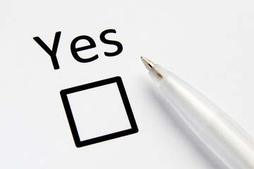 Questionnaire. Inscription YES with check mark on white paper