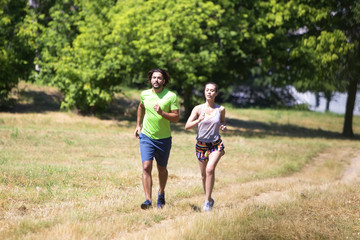 Healthy, fit and  sportive couple running in park