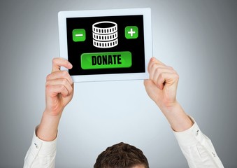 Man holding tablet with donate button and money for charity