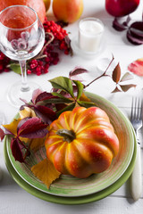 decorated table with pumpkin and candleholder.