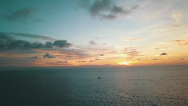 Aerial view of sunset sea with paragliders