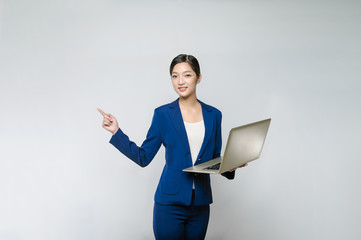 Asian Young Woman use of notebook computer and finger point up