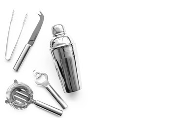 Barman equipment. Shaker, strainer on white background top view copyspace