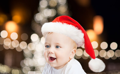 little baby boy in santa hat at christmas