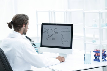 research scientist using computer chemistry laboratory