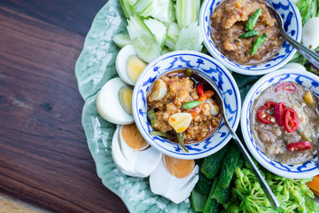 Thai food is 3 chili paste decorated with fresh side vegetables, boiled eggs.
