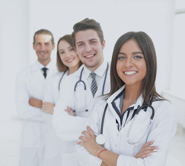 female doctor with group of happy successful colleagues