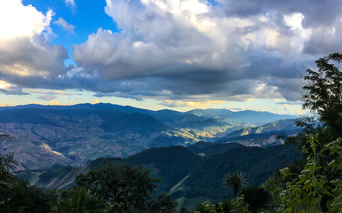 The nature landscape from trekking at Doi Phu Wae, Nan, Thailand. The moment of the bright sunlight shine toward the valley of hills with the great texture of mountain below the shade of cloudy sky