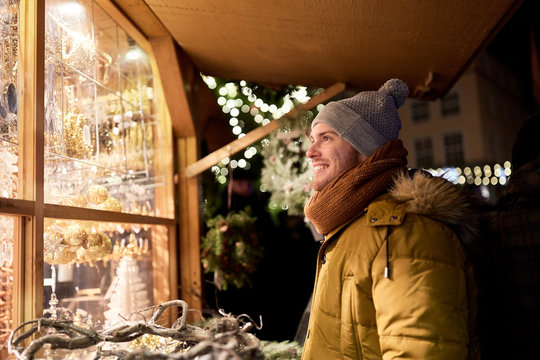 Happy Man Looking At Christmas Market Shop Window