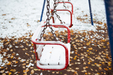 First snow. Swing in the city Park.