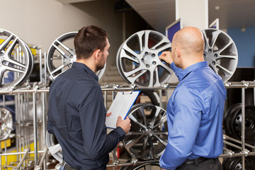 customer and salesman at car service or auto store