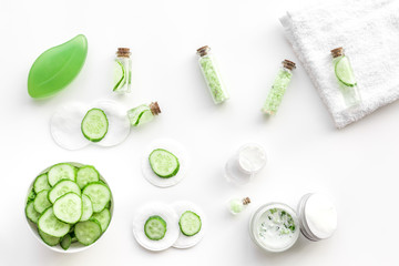Fresh organic cosmetics with cucumber. Cream and lotion on white background top view