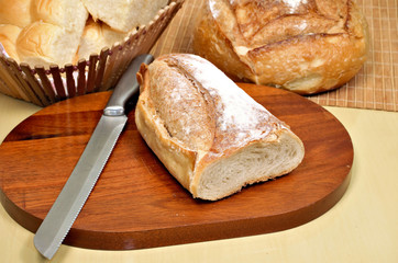 Delicious breads on wooden table seen from above.