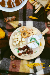 Fototapeta premium Cheese Mix on Wooden Board, Autumn Picnic Background
