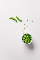 Healthy bowl of green pea on white background. Top view with copy space.