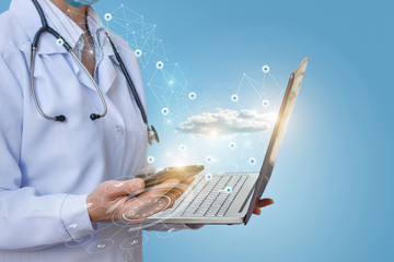 Doctor works on phone and laptop at medical network .
