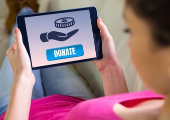 Woman holding tablet with donate button and hand giving money