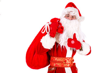 Santa Claus standing up on white background with his bag full of gifts. Show thumb up