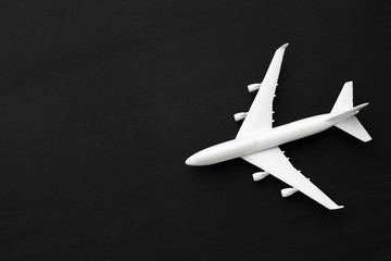 Fototapeta na wymiar Miniature airplane on black background