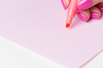 Female hand holding a pen close up