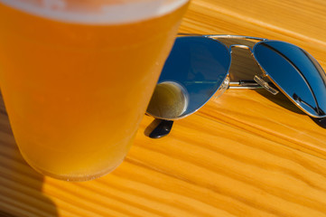 sun glasses on a park bench or table splash fresh