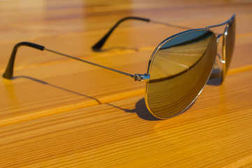 sun glasses on a park bench or table splash fresh