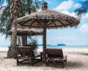 Lounge chairs and sunshade umbrella on the beach