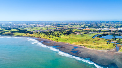 Aerial view on Taranaki coastline with a small river and New Plymouth on the background. Taranaki region, New Zealand