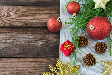 Christmas decoration decorations, bows, ribbons, fir branches, Christmas balls on a wooden background with copy space festive mood and atmosphere