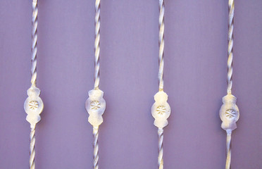 Metal patterns on a twisted metal rod on a purple background.