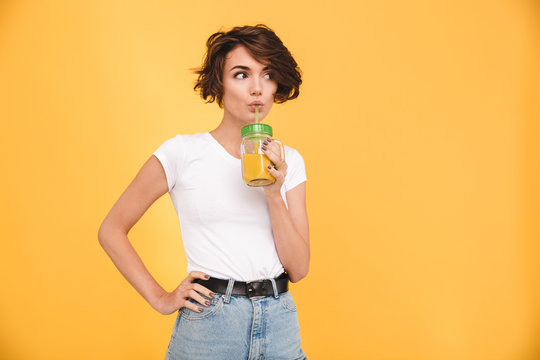 Portrait Of A Cute Casual Girl Drinking Orange Juice