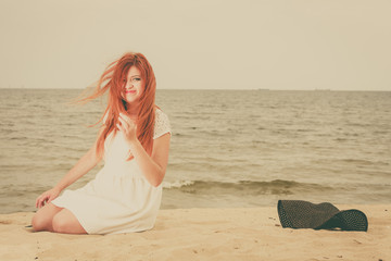 Redhead adult woman lying on beach