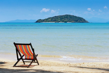 Beach chairs on idyllic tropical sand beach.