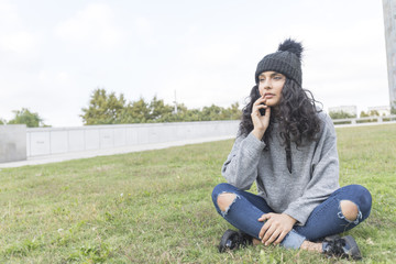 portrait of a woman with wool cap and sweater in park