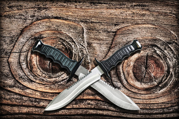 Tactical Combat Hunting Survival Bowie Knives With Crossed Blades On Grunge Vignetted Old Knotted...