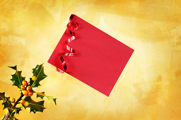 Holiday  envelope over a holly and hand painted gold background